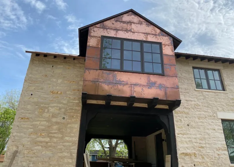Copper metal panel facade on a stone building for Roof Repair in Drexel Heights